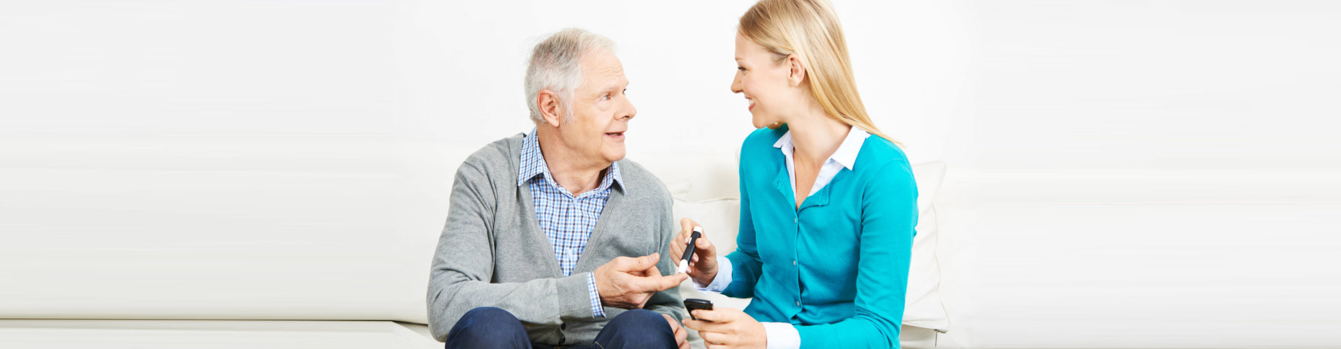 A woman is talking to an older man