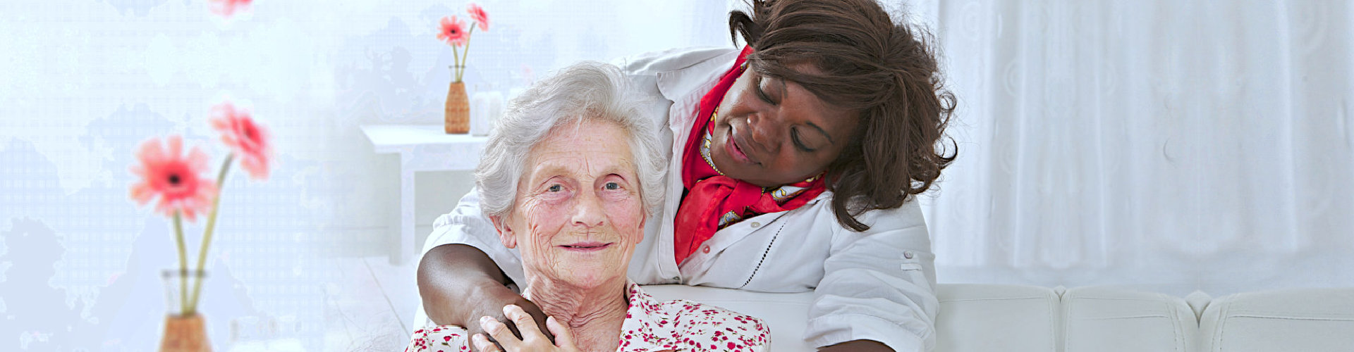 A woman is hugging an older lady