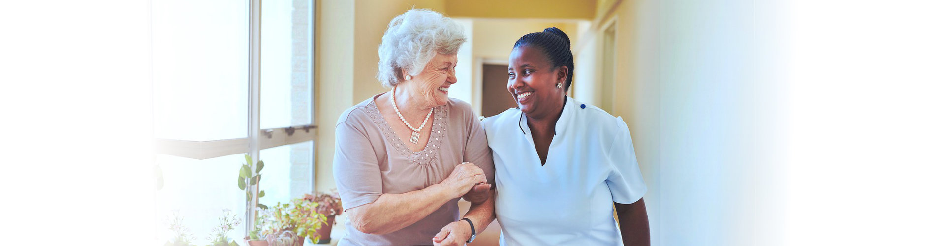 A woman and an older person smiling for the camera.